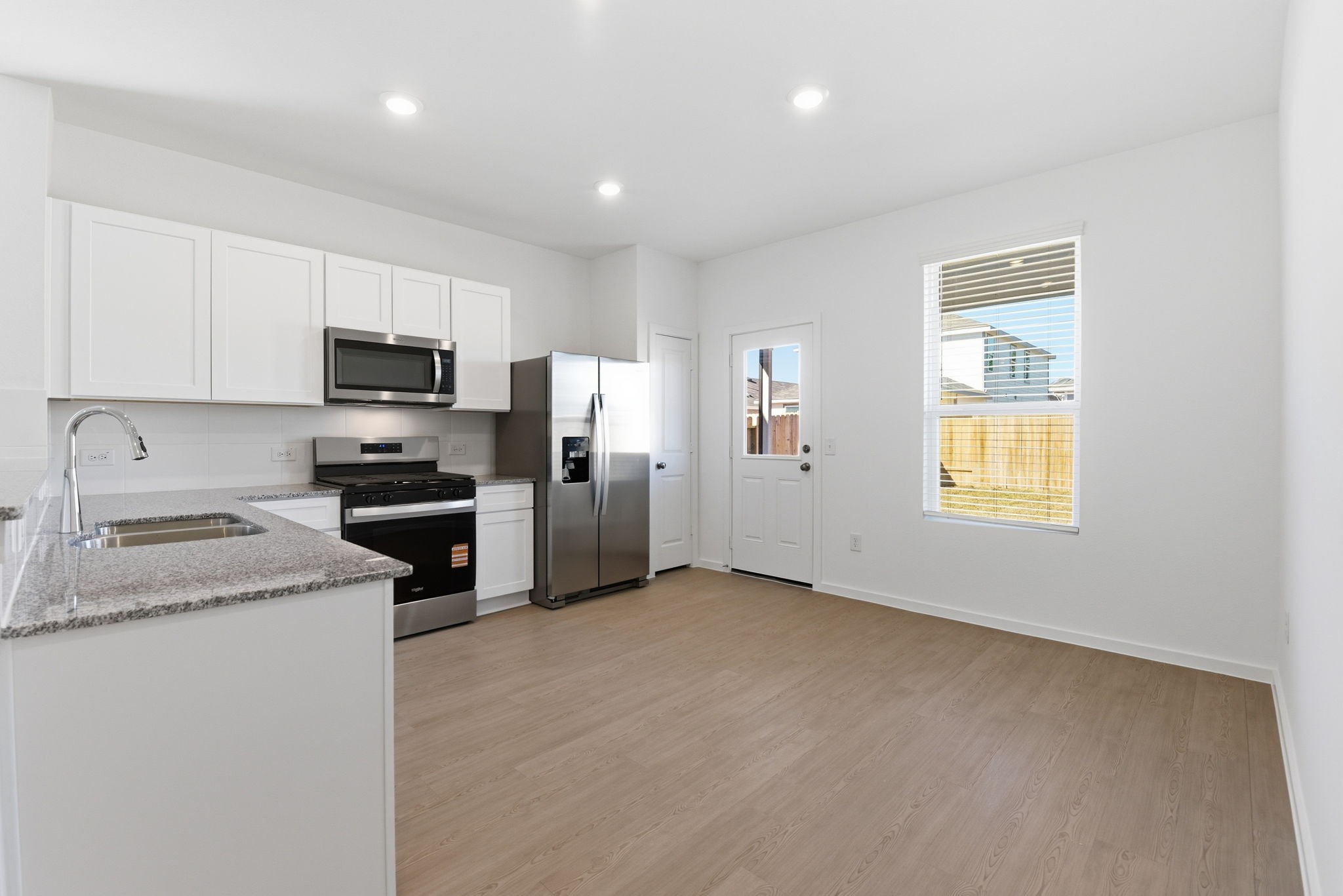 26283 Arrowleaf Drive Magnolia, TX 77355 - Photo 11 of 34 a kitchen with a refrigerator stove and microwave