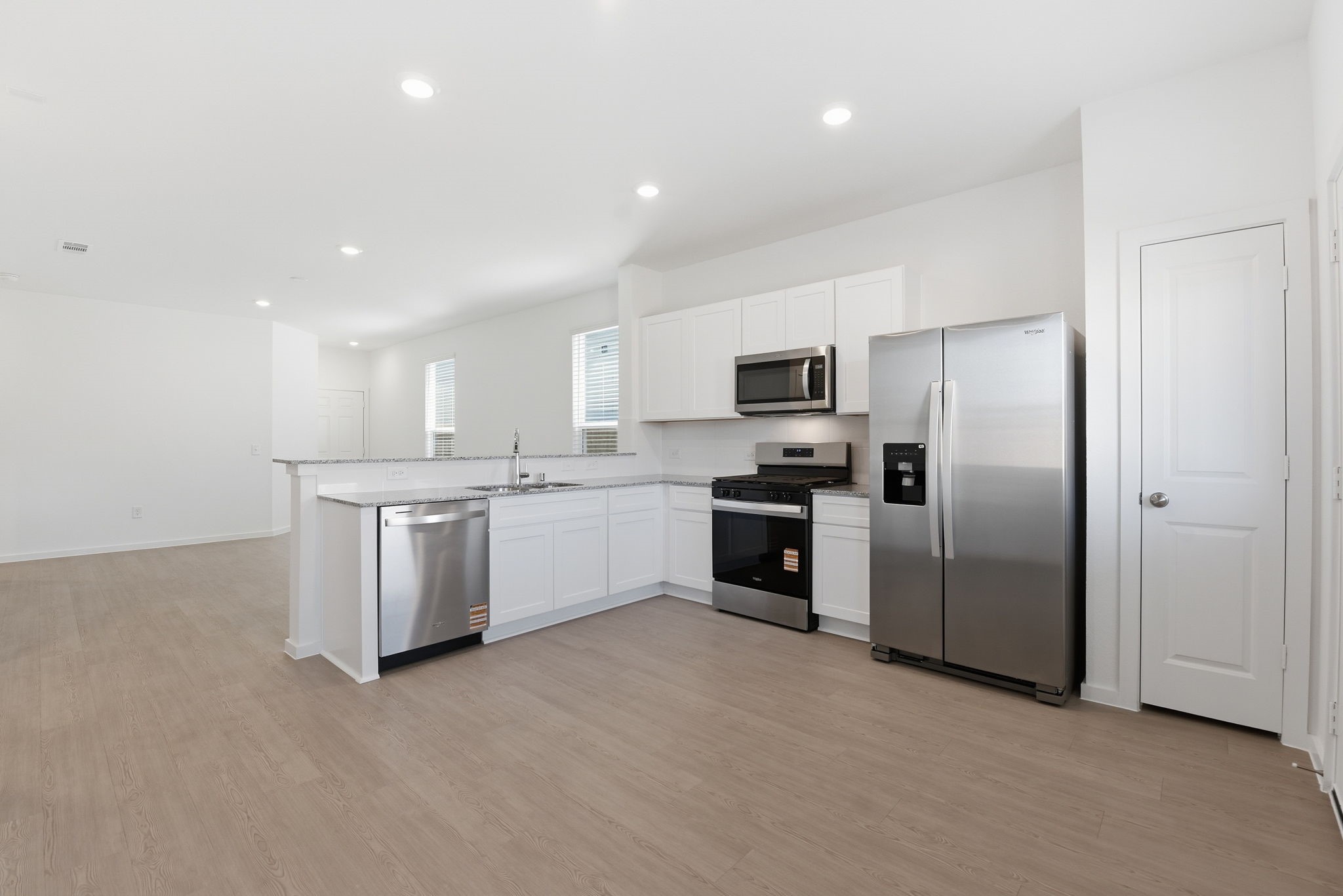 26283 Arrowleaf Drive Magnolia, TX 77355 - Photo 12 of 34 a kitchen with refrigerator a sink and cabinets