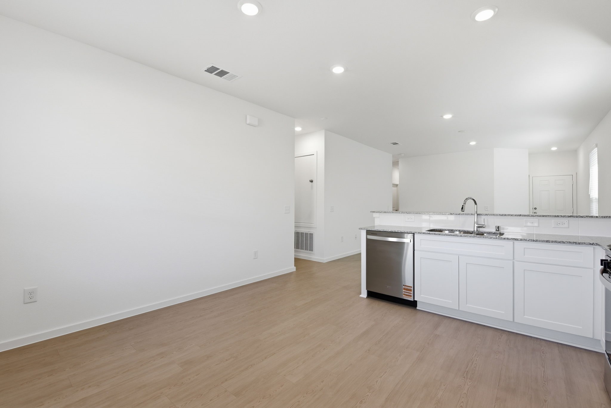 26283 Arrowleaf Drive Magnolia, TX 77355 - Photo 14 of 34 a large kitchen with a sink and dishwasher a stove top oven with white cabinets