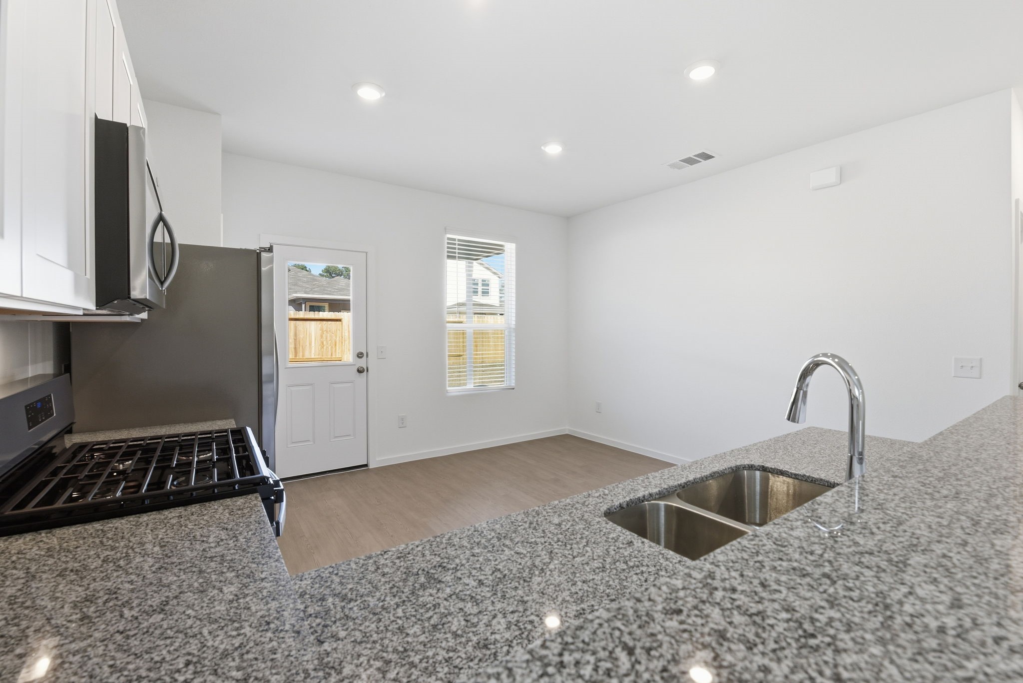 26283 Arrowleaf Drive Magnolia, TX 77355 - Photo 16 of 34 a kitchen with sink a faucet and appliances