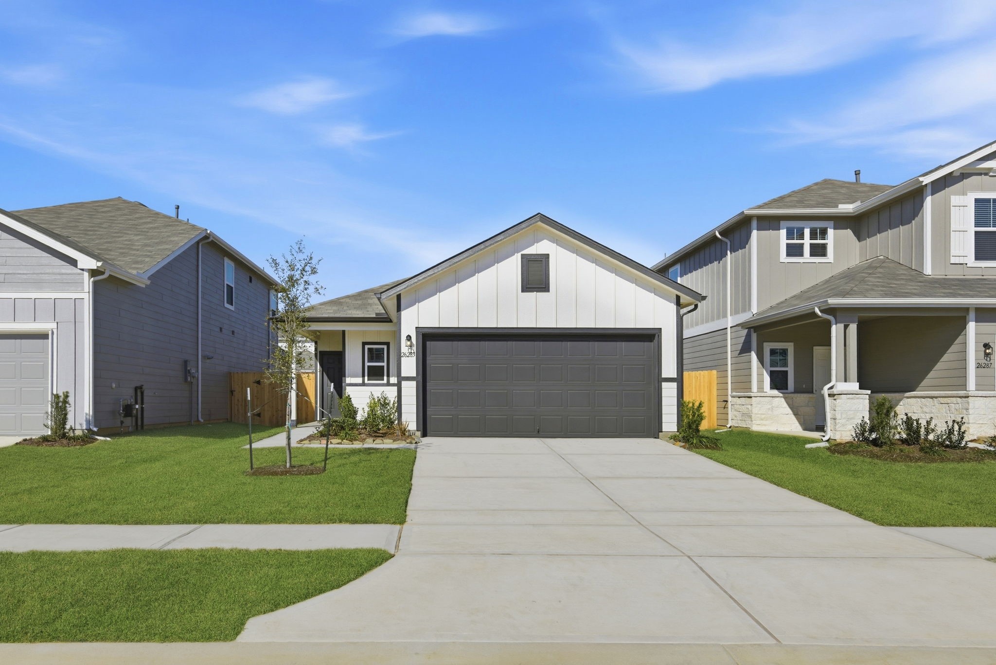 26283 Arrowleaf Drive Magnolia, TX 77355 - Photo 2 of 34 a front view of a house with a yard and garage