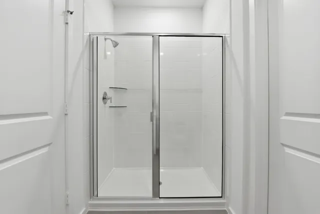 a bathroom with a glass shower door