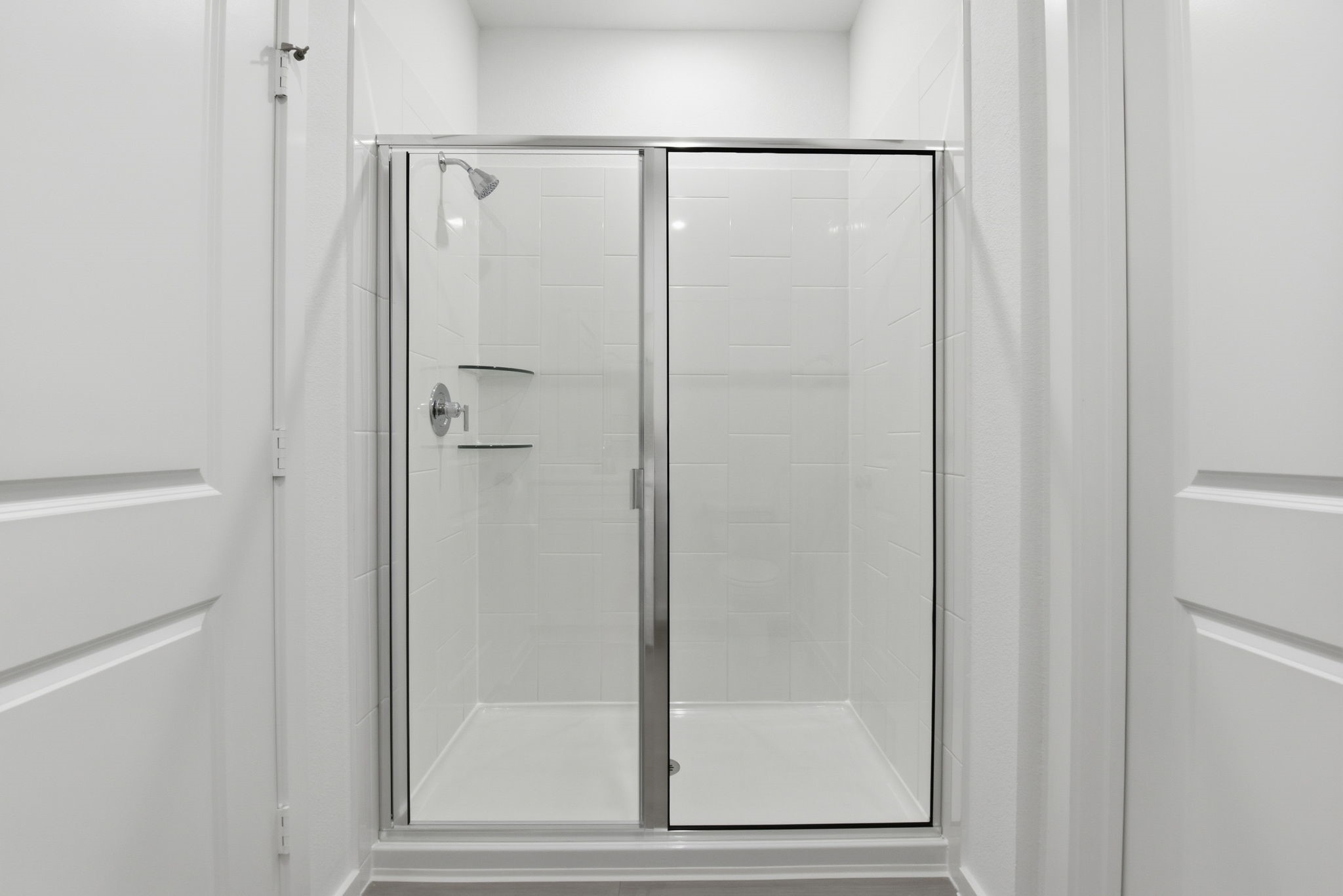 26283 Arrowleaf Drive Magnolia, TX 77355 - Photo 23 of 34 a bathroom with a glass shower door