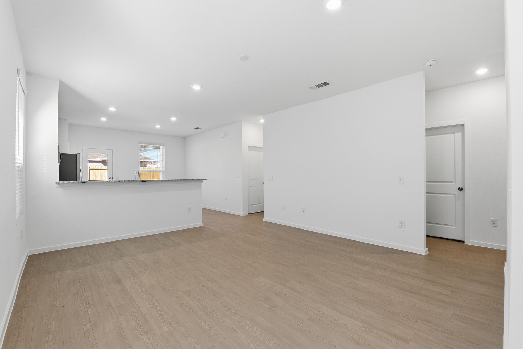 26283 Arrowleaf Drive Magnolia, TX 77355 - Photo 9 of 34 an empty room with wooden floor and windows