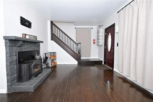 a view of a livingroom with wooden floor and staircase