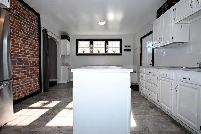 a utility room with cabinets washer and dryer