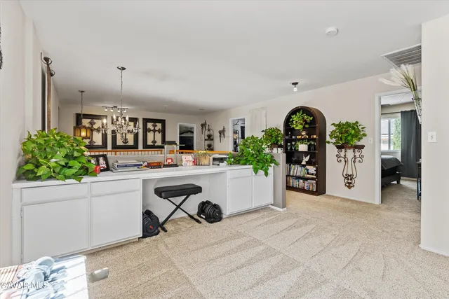 a room with kitchen island and living room