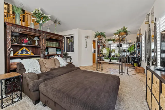 a bedroom with furniture and a flat screen tv