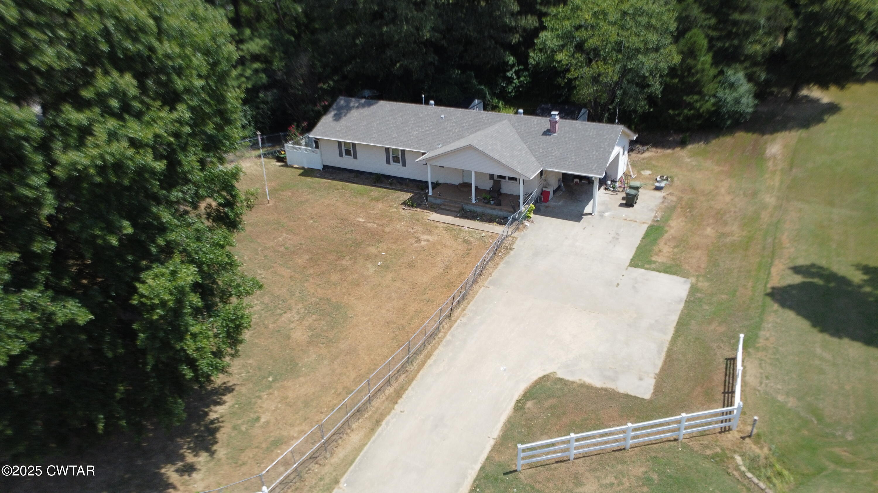 an aerial view of a house with yard