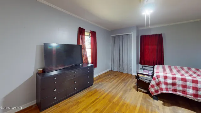 a bedroom with a bed and a flat screen tv