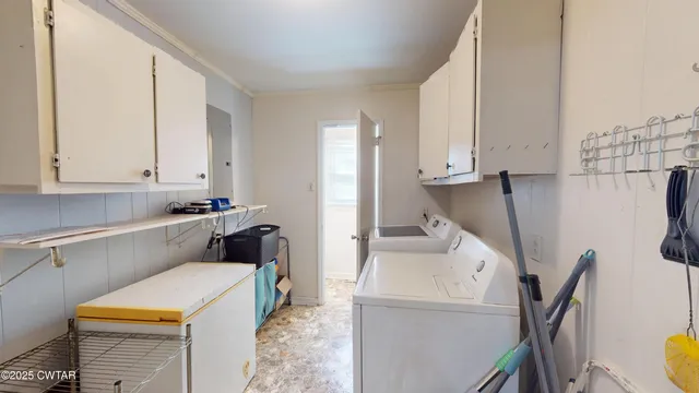 a utility room with sink dryer and washer