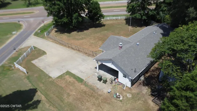 an aerial view of a house with a yard