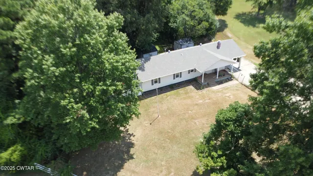 an aerial view of a house with yard