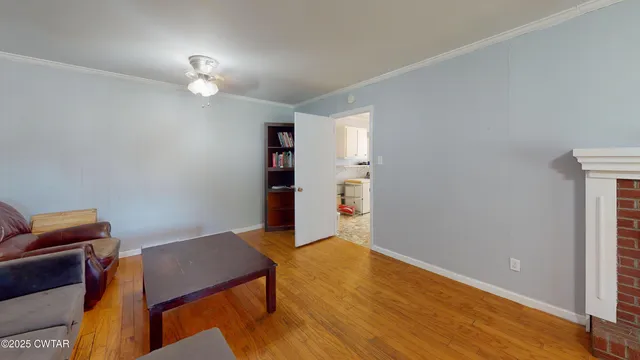 a furnished livingroom with a workspace