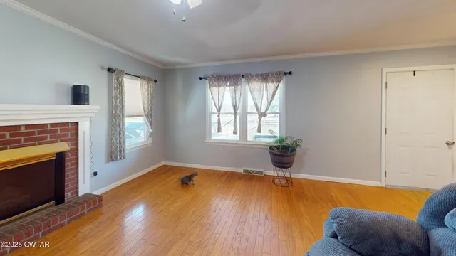 a view of livingroom with furniture fire place and windows