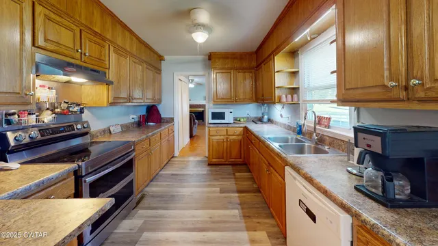 a kitchen with kitchen island granite countertop lots of counter top space and stainless steel appliances