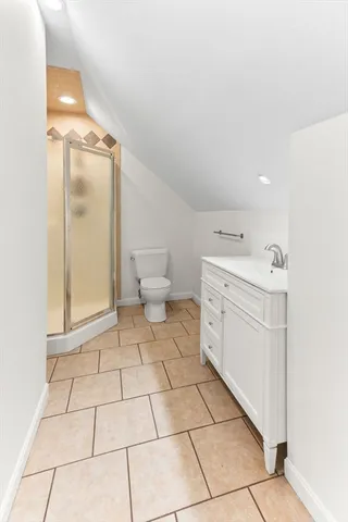 a bathroom with a sink mirror and shower