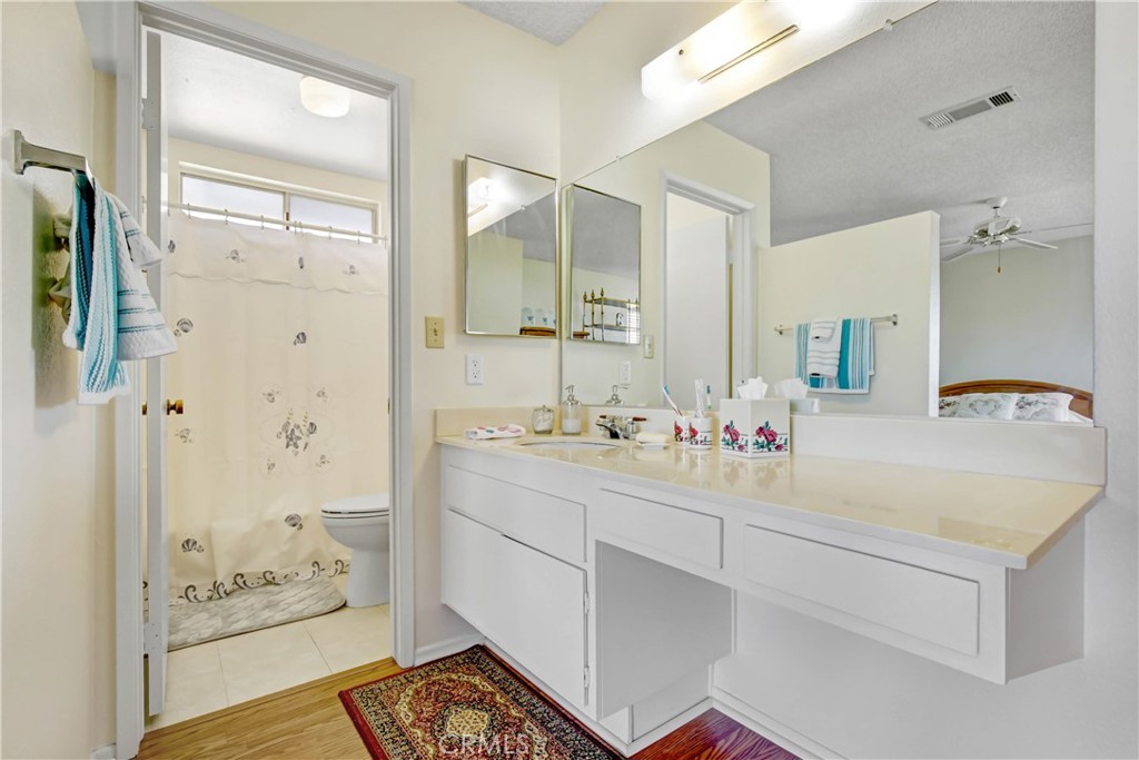26490 McCall Boulevard Menifee, CA 92586 - Photo 9 of 14 a bathroom with a double vanity sink mirror and shower