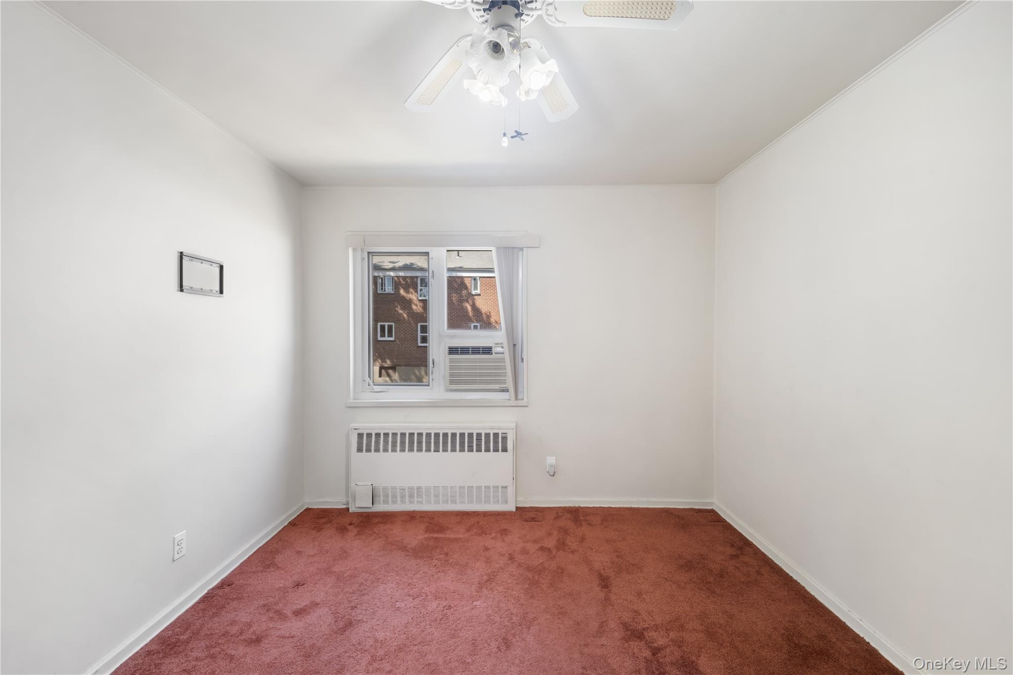 226-29 Manor Road, Unit UPPR Queens, NY 11427 - Photo 12 of 17 an empty room with a chandelier fan and windows