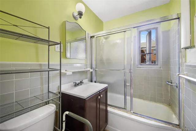 a bathroom with a sink mirror and a shower