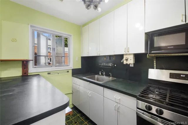 a kitchen with a sink stove and microwave