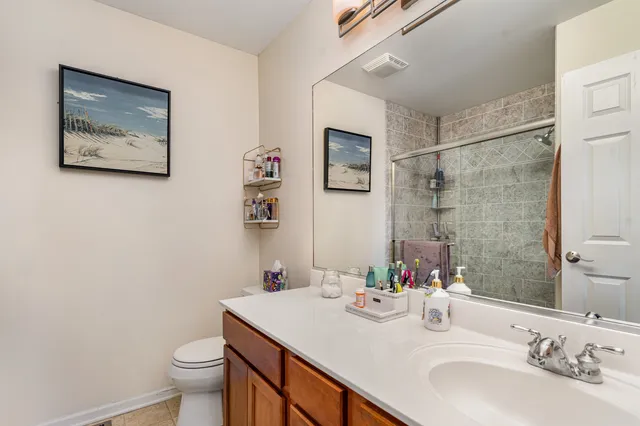 a bathroom with a sink toilet and a mirror