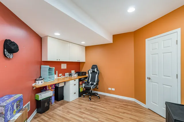 a view of a workspace with furniture and wooden floor