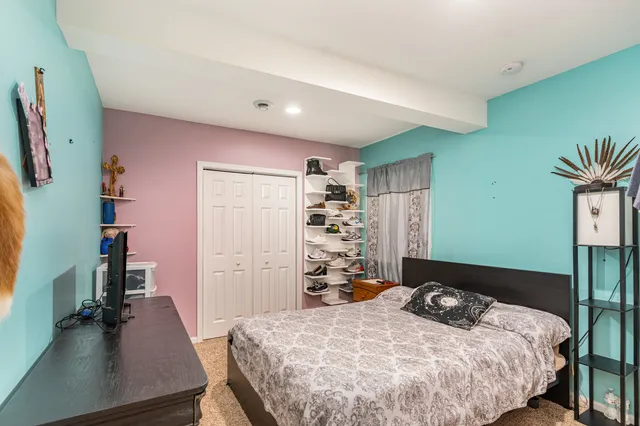 a bedroom with a bed and a flat screen tv