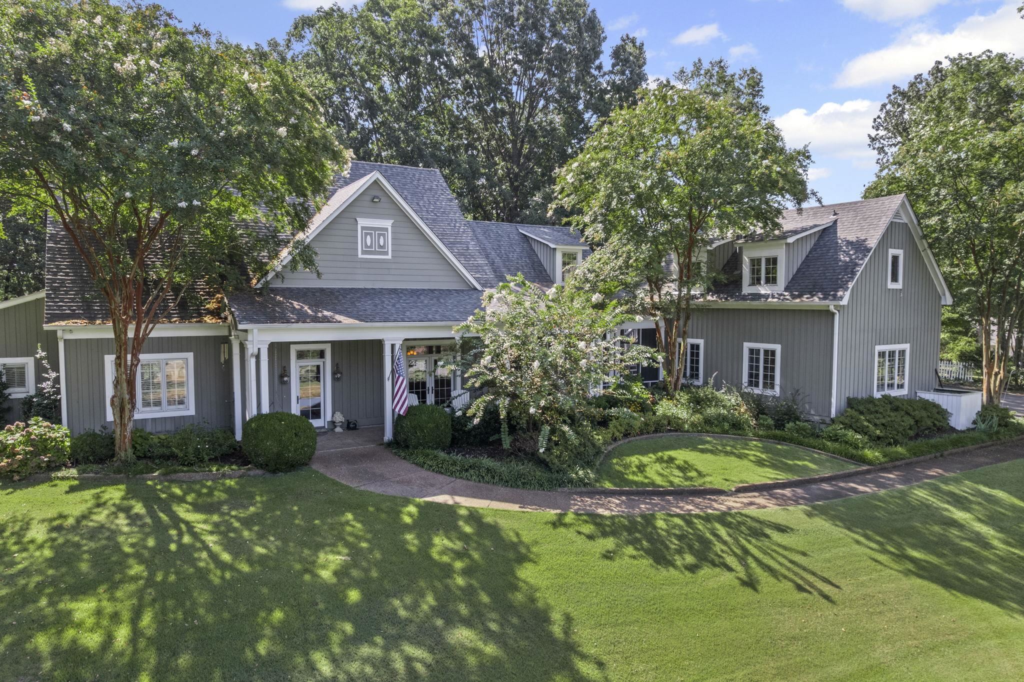 a front view of a house with a garden