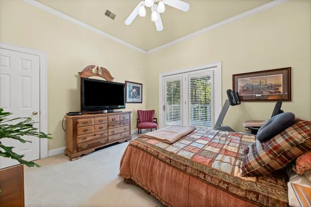 a living room with furniture and a baby crib