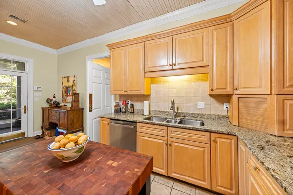 a kitchen with stainless steel appliances granite countertop a stove refrigerator sink and cabinets