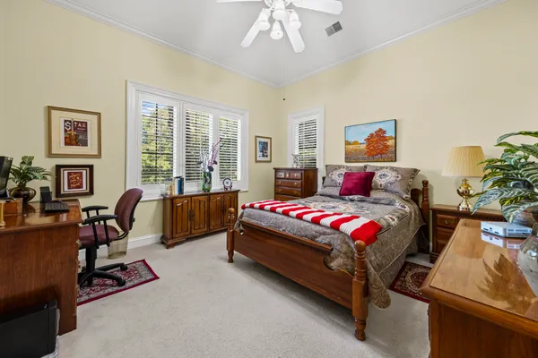 a bedroom with a bed and a couch