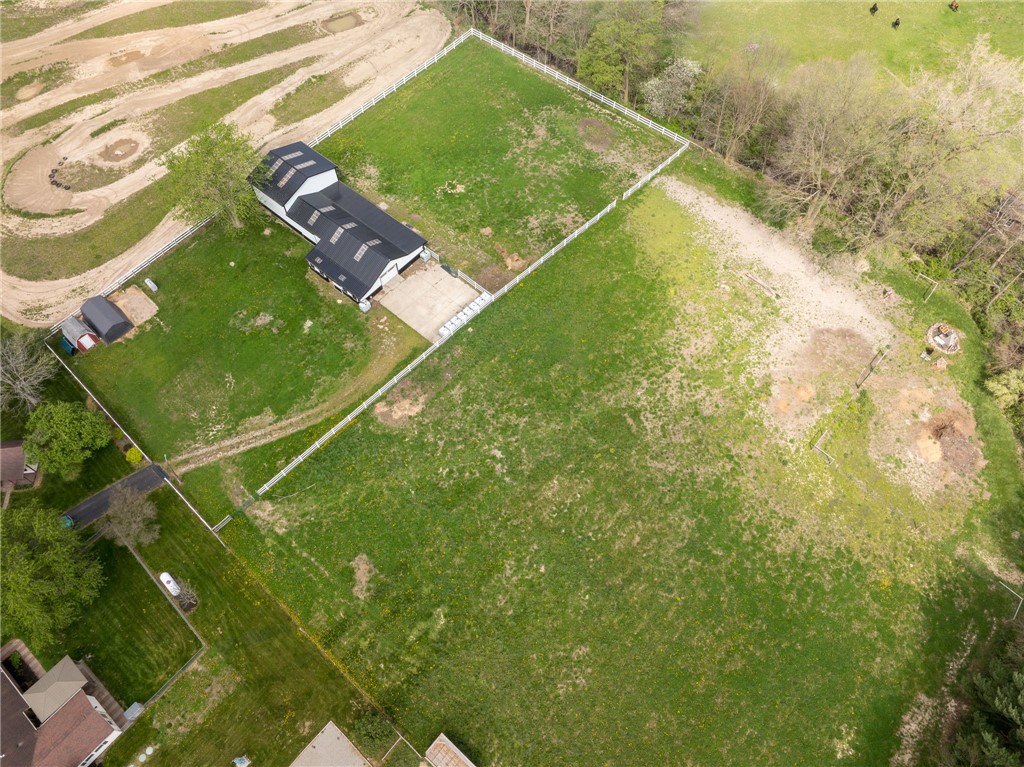 7988 McCool Road Greenville, OH 45331 - Photo 42 of 50 Expansive green property featuring a modern structure, multiple outbuildings, and a concrete driveway.
