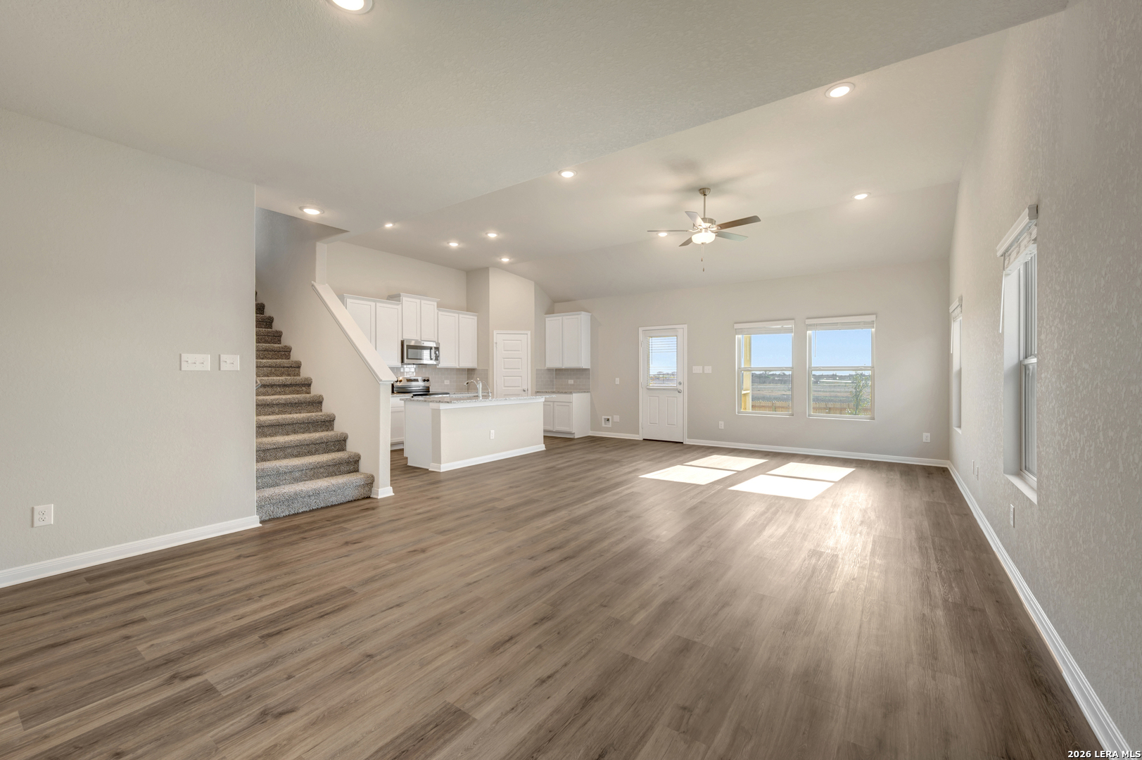 10330 Goodison Drive Converse, TX 78109 - Photo 11 of 42 a view of empty room with wooden floor and kitchen