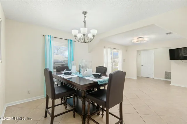 a view of a dining room with furniture wooden floor and chandelier