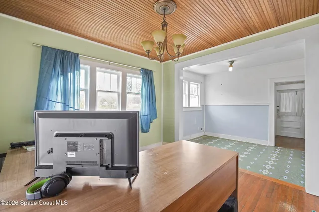 a living room with fireplace furniture and a chandelier