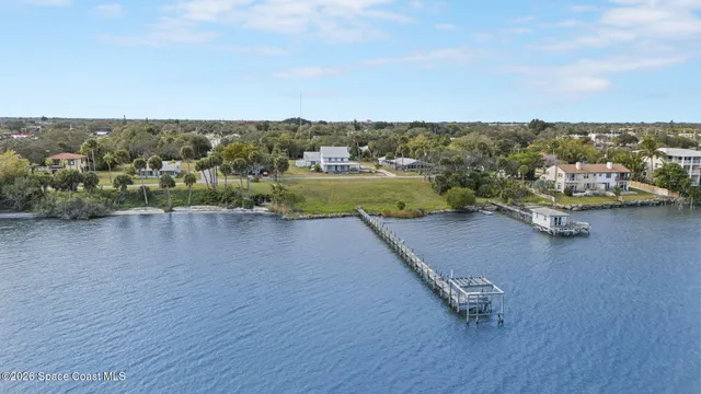 an aerial view of a residential houses with yard
