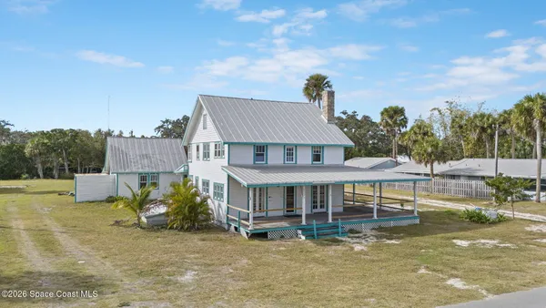 an aerial view of a house with a ocean view