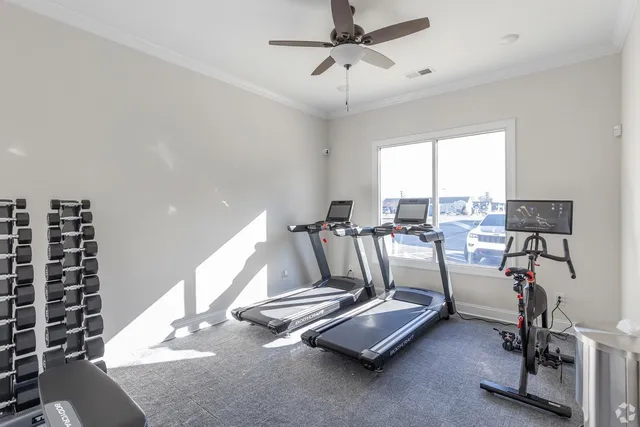 a room with gym equipment and windows