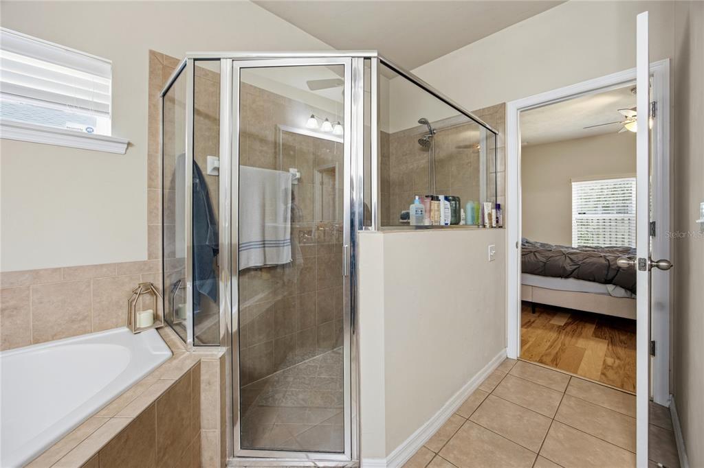 7550 Southwest 81st Way Gainesville, FL 32608 - Photo 20 of 31 a en suite bathroom with a granite countertop sink mirror and shower