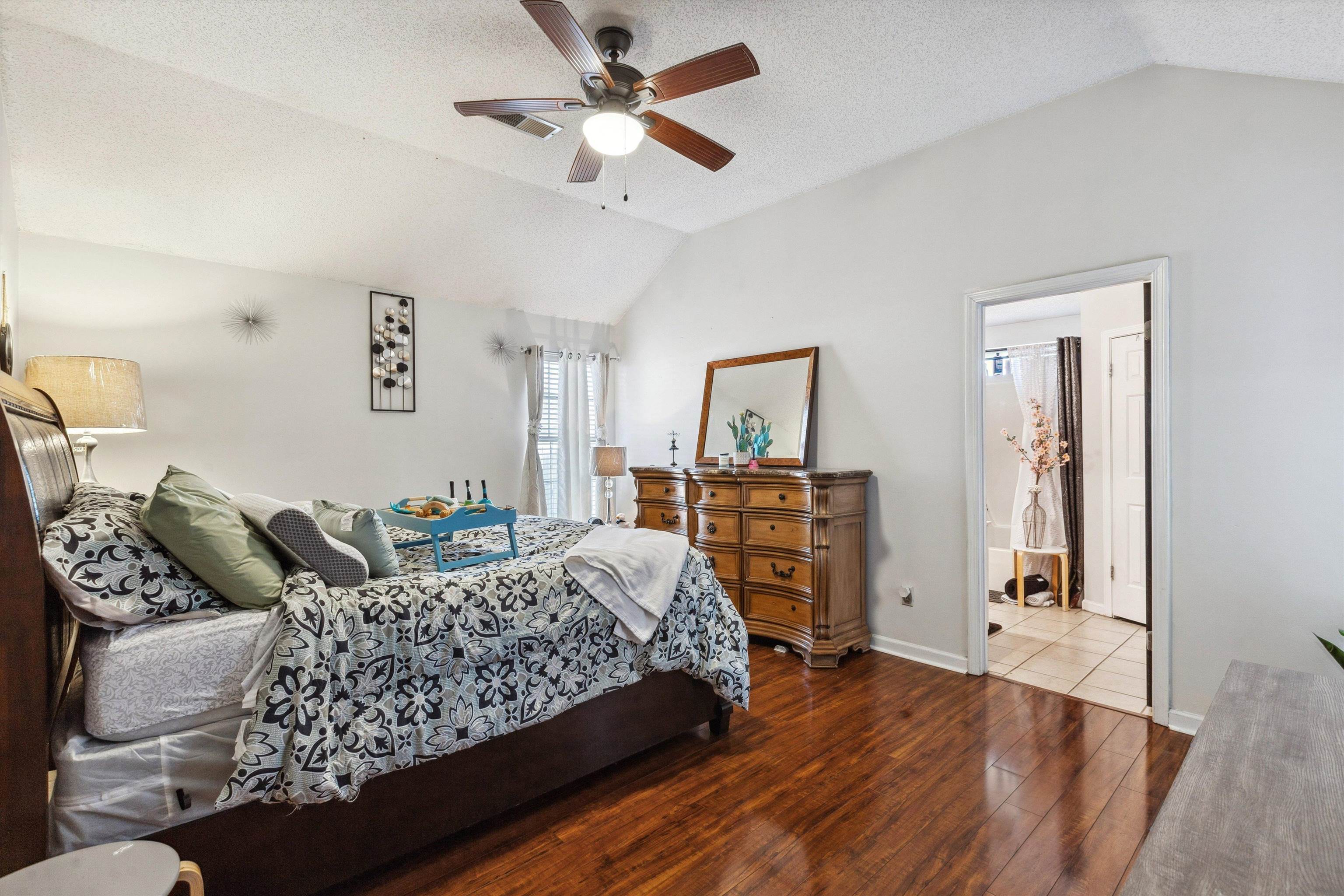 4120 Long Creek Road Memphis, TN 38125 - Photo 14 of 26 Spacious Primary Bedroom ft. a vaulted ceiling, en-suite bath and door to backyard patio.