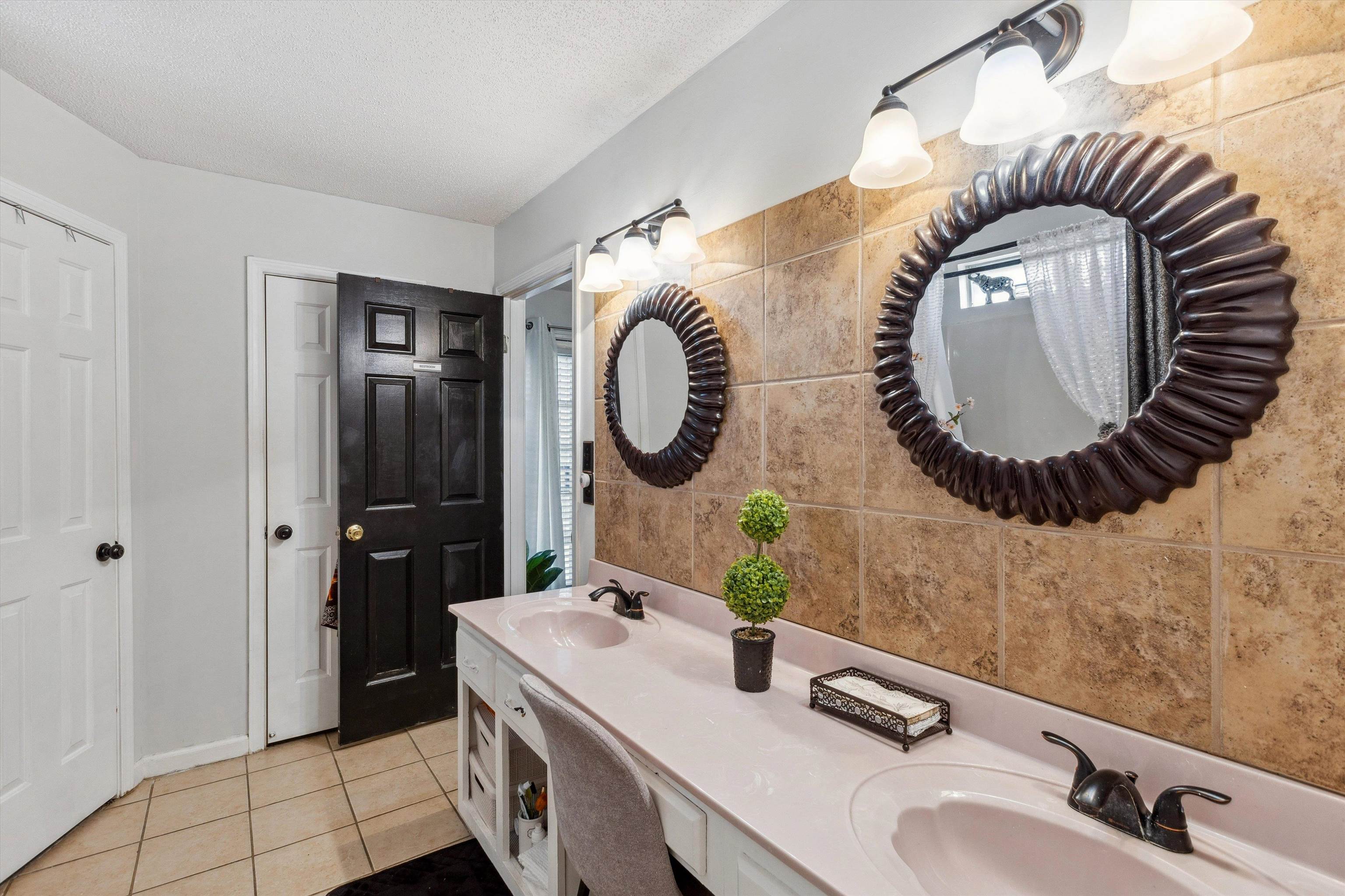 4120 Long Creek Road Memphis, TN 38125 - Photo 17 of 26 Luxury bathroom featuring two walk-in closets, linen closet, tile patterned floors, double vanity, and a shower/tub combo.