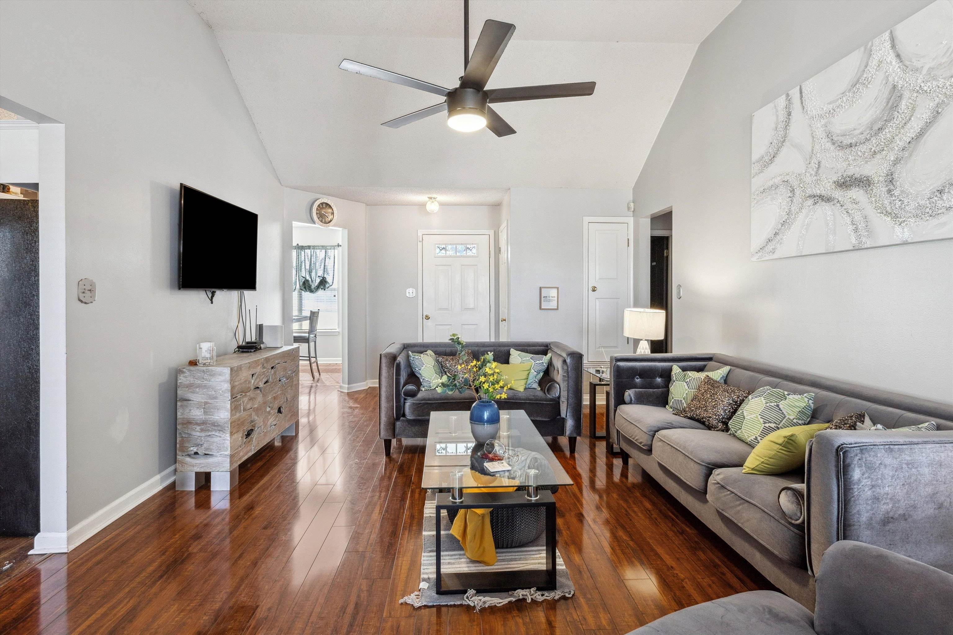 4120 Long Creek Road Memphis, TN 38125 - Photo 7 of 26 Living area featuring vaulted ceiling, a ceiling fan, and laminate wood flooring