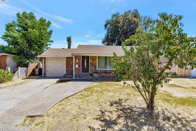 a view of a house with yard and sitting area