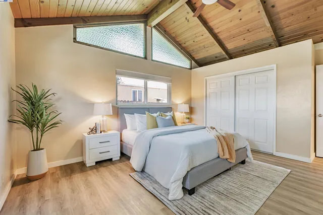 a bedroom with a bed and a potted plant