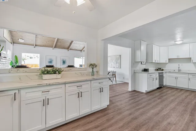 a kitchen with cabinets appliances a sink and a counter top
