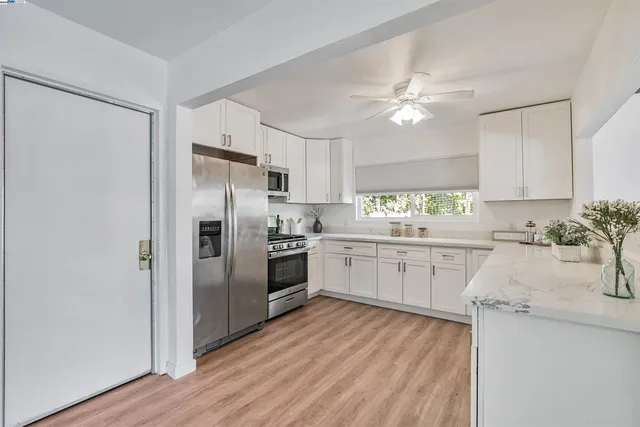 a living room with furniture a table and a large window