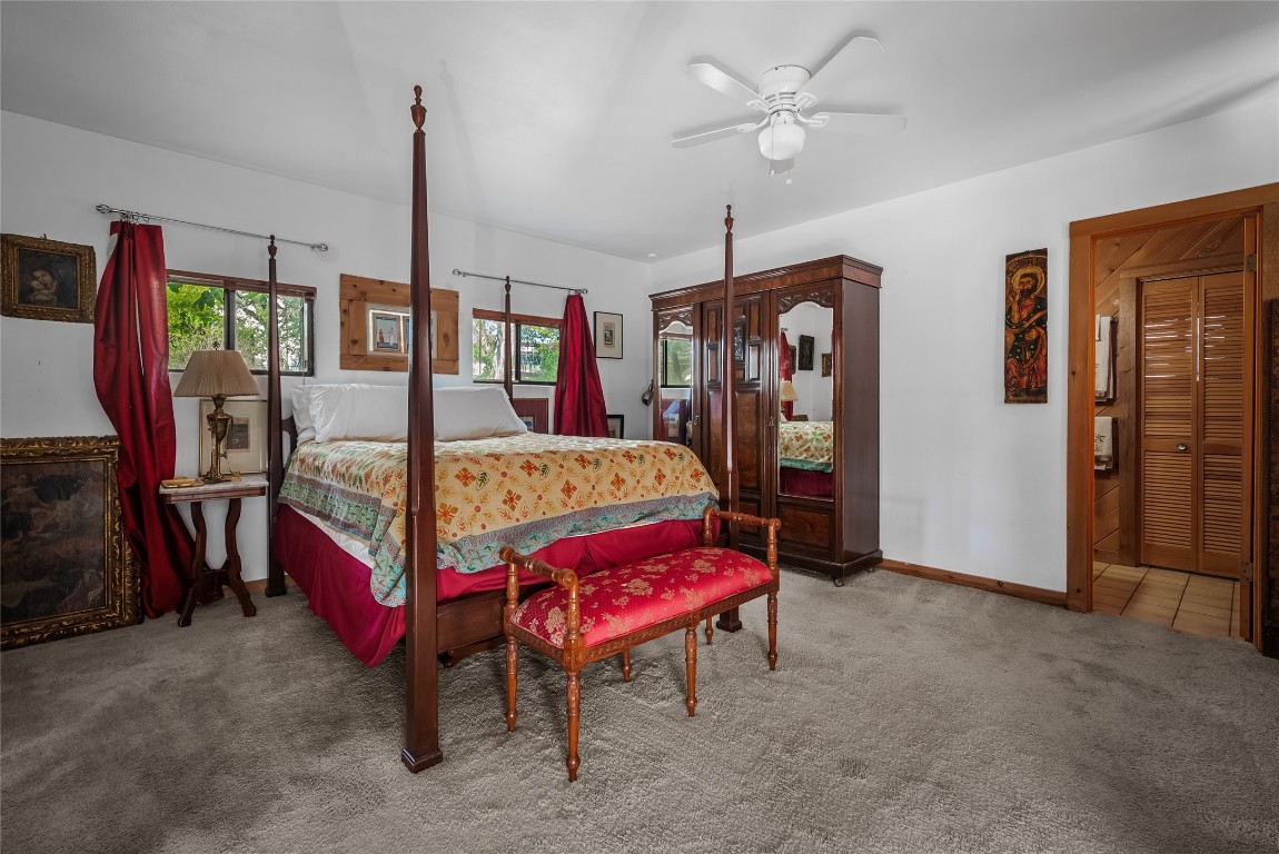 16020 Pool Canyon Road Austin, TX 78734 - Photo 20 of 29 a bedroom with furniture and a chandelier