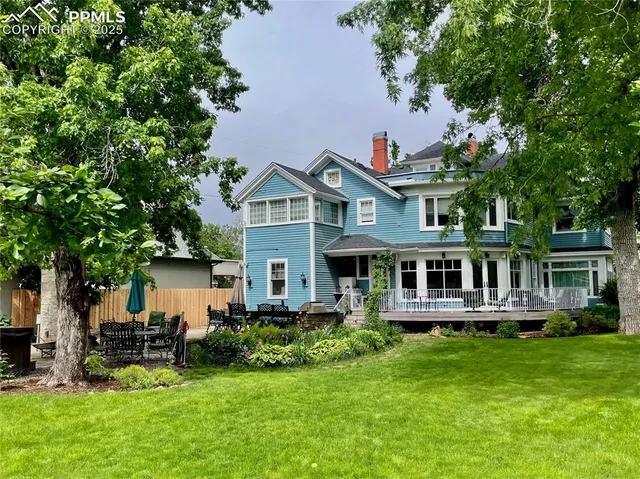a front view of a house with a garden and plants
