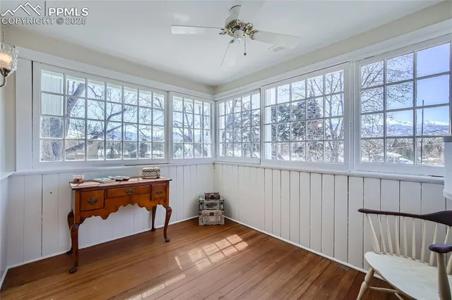 a view of a room with wooden floor and furniture